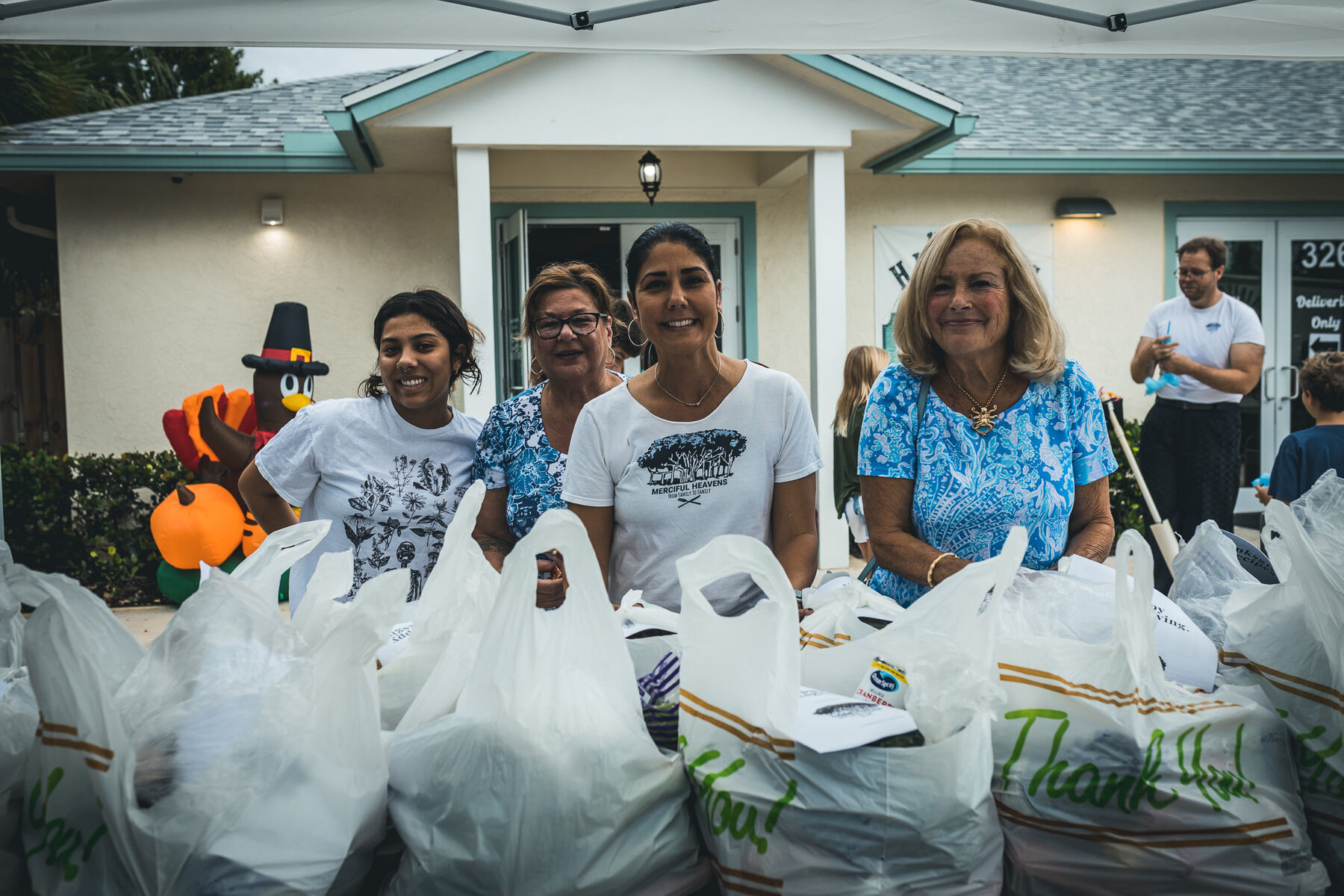 Volunteers loading bagged groceries onto a delivery truck